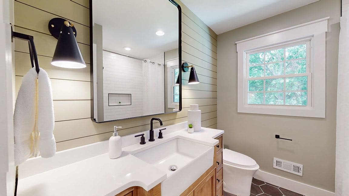 Kitchen with navy island, white quartz counters, and warm wood cabinets
