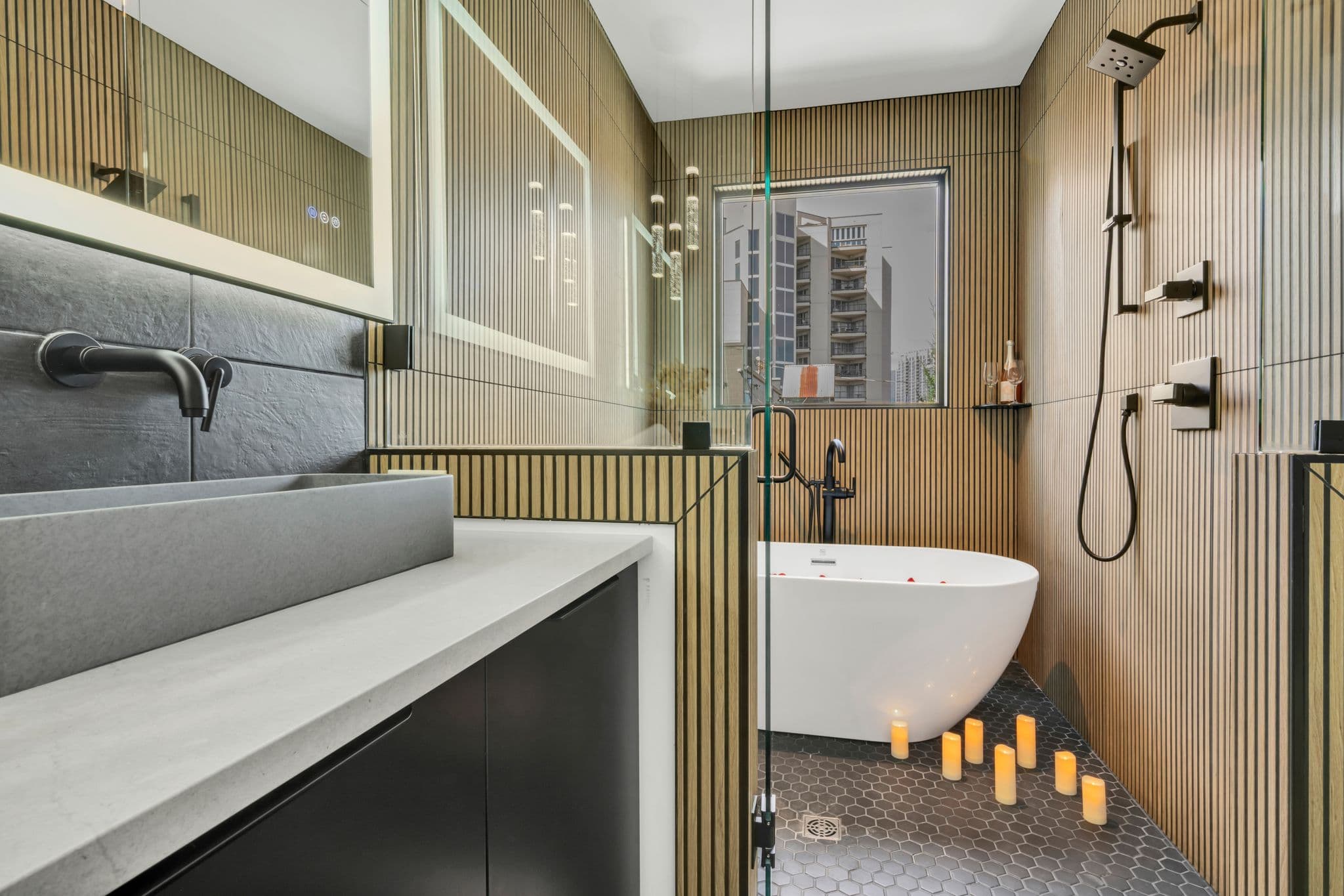 Spa bathroom with freestanding tub, walk-in shower, and warm wood slat walls