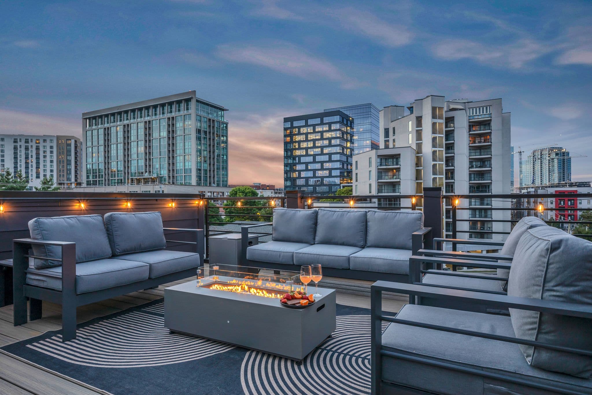 Rooftop lounge with fire table overlooking the Nashville skyline